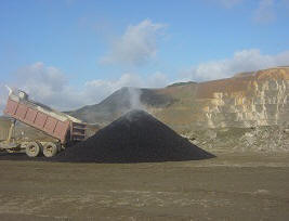 dump truck unloading green asphalt